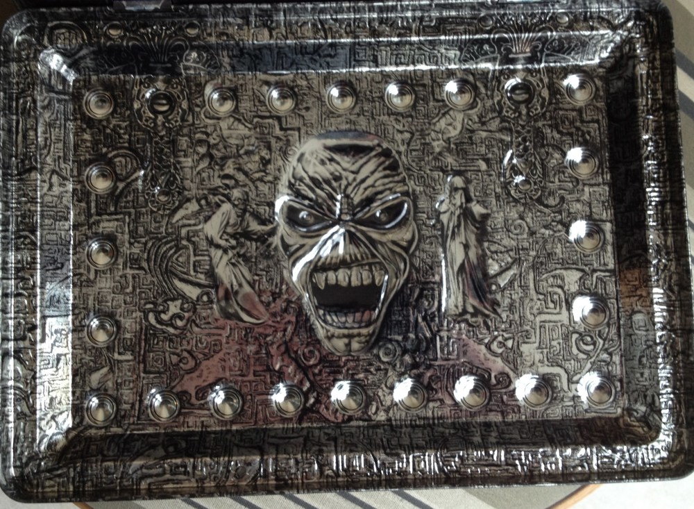 A parte de dentro da tampa trazendo os mesmos ricos detalhes da frente, côncavos